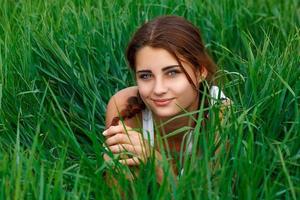 portrait of a young woman in green grass photo