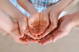 Large family holds palms their hands together, concept happiness in the family photo