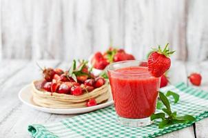 Pancakes with berries and strawberry smoothie in a rustic style photo
