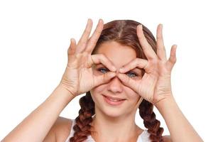 cheerful smiling girl shows hand gesture all OK on white isolated background photo