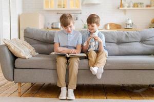 Teach your child to read book as teenager. Caucasian child looking into book photo