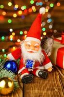 happy rat on with Santa Claus and gift on wooden background multicolored bokeh photo