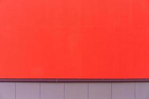 Painted red walls of house, facade as textured background. Wide wall textured photo
