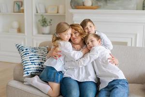 Cute kids hugging, excited mom showing love and affection, smiling mother photo