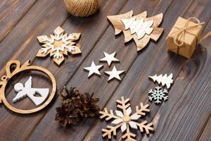 Christmas composition. Christmas snowflakes, Christmas tree and angel in a frame on a wooden background. New Year wooden decorations photo