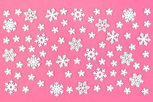 Top view of winter ornament made of white snowflakes on colorful background. Happy New Year concept with copy space photo