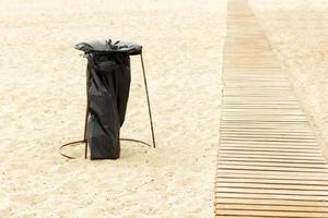 homemade Garbage container from a garbage bag on the beach photo