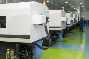 The workers in the workshop with molding machine for the production of medical production photo