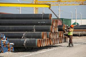 A line of oilfield large streel pipes in industrial construction area photo