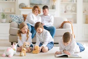 Happy young caucasian family resting in a new cozy design home on weekends. photo