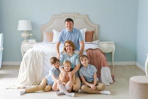 Portrait large family five people father mother two sons and daughter lying photo