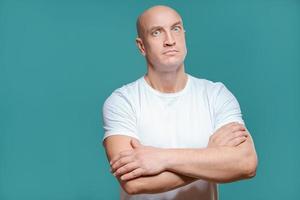 emotional man in white t-shirt with angry facial expression on background, isolation photo