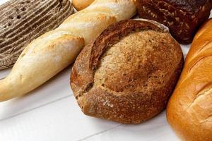 assorted of bread on white wooden background photo