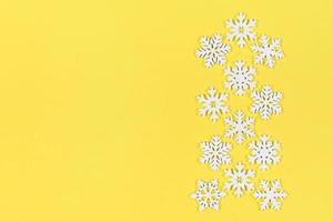 Top view of white snowflakes on colorful background. Winter weather concept with copy space. Merry Christmas concept photo