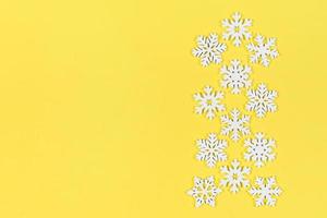 Top view of white snowflakes on colorful background. Winter weather concept with copy space. Merry Christmas concept photo