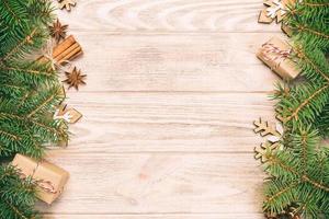 Christmas background with fir tree and gift box on vintage, toned wooden table. Top view with copy space for your design photo