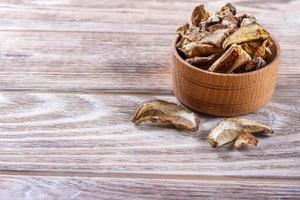 dried porcini mushroom on a wooden table photo