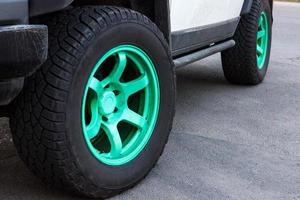 jeep with green wheel disks on the road photo