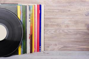 Vinyl records and headphones on table. Vintage vinyl disk photo