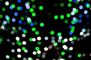 Unfocused abstract colourful bokeh on black background. defocused and blurred many round light photo