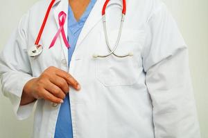 Asian woman doctor with pink ribbon, World Breast Cancer Day at October. photo