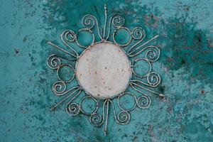 Iron background with beautiful ornament with a sun. photo