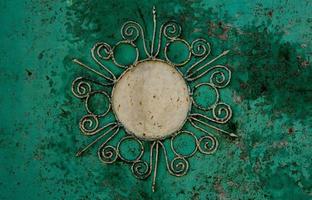 Iron background with beautiful ornament with a sun. photo