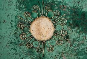 Iron background with beautiful ornament with a sun. photo