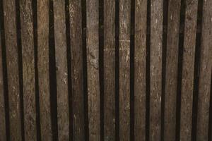 Vintage brown wood background texture with knots and nail holes. Old painted wood wall. Brown abstract background. Vintage wooden dark horizontal boards. photo