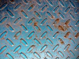 Metal Plate With Diamond Pattern.Already rusty ferrous metal background photo