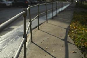 Handrail by road. Pedestrian barrier. Fence along road. photo