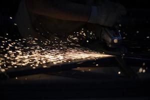 Grinding of steel. Sparks from metal. Hot particles. photo