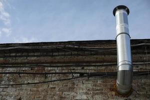 Pipe on building. Industrial building. Wall of bricks. photo