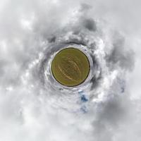 tiny planet in blue sky with beautiful clouds. Transformation of spherical panorama 360 degrees. Spherical abstract aerial view. Curvature of space. photo