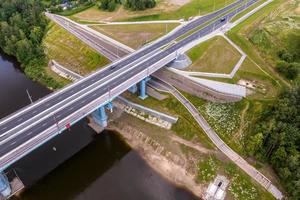 aerial view on huge bridge with a wide multi-lane road across a wide river photo