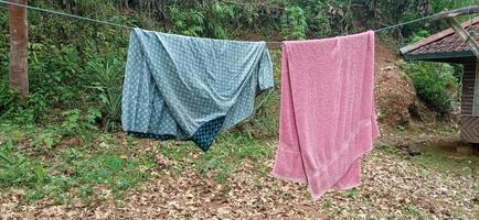 Simple clothesline in the yard in the village. photo