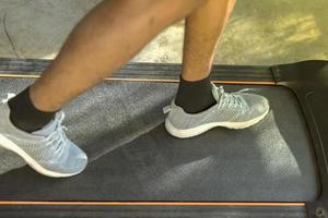 A man walking and exercising on a treadmill. photo