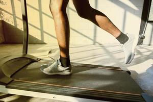 A man walking and exercising on a treadmill. photo