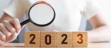 2023 block with magnifying glass. SEO, Search Engine Optimization, hiring , Advertising, Idea, Strategy, marketing, Keyword, Content and New Year start concepts photo