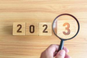 2023 block with magnifying glass. SEO, Search Engine Optimization, hiring , Advertising, Idea, Strategy, marketing, Keyword, Content and New Year start concepts photo