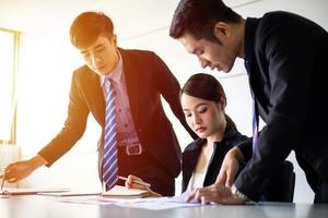 Asian businessmen working and sharing ideas meeting in company conference room photo