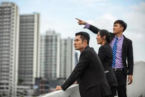 A group of business women and business men working outside the office. photo