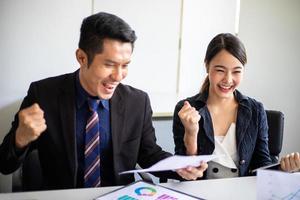 Asian business men and women express joy and happiness in the successful work in the meeting room photo