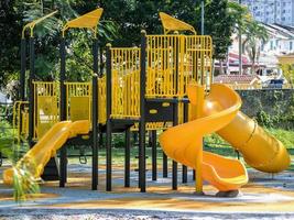 Profile view of a yellow children playground setup photo