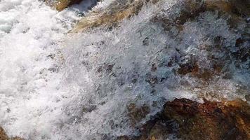 Defocus blurred transparent white water running. Waterfall. White water splash, surface texture with splashes and bubbles. Trendy abstract nature background. Water falling on the stone. video