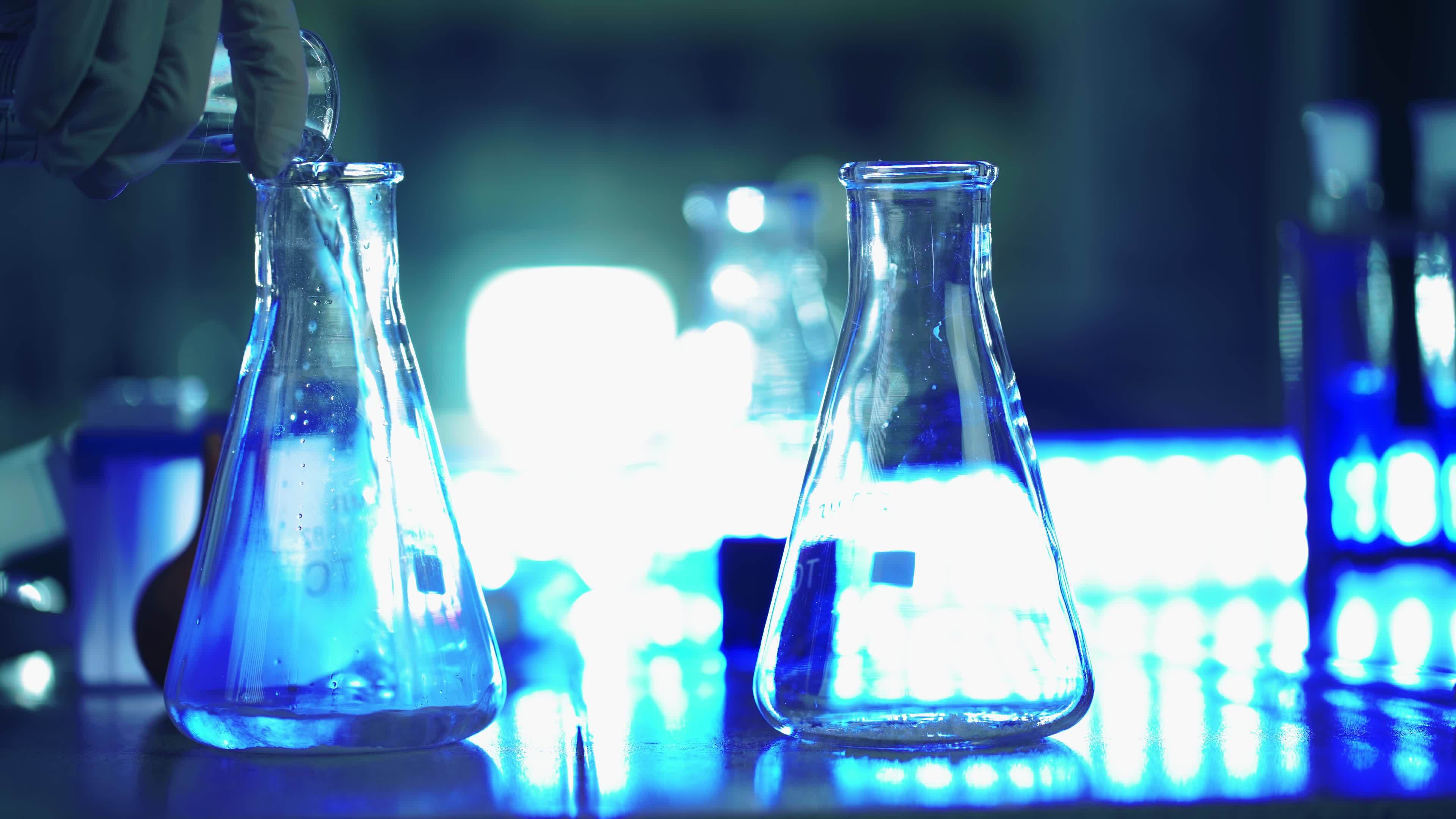 cientist in laboratory doing chemical experiment with liquid in tube