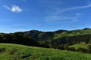 Grass Fields and Rolling Hills in the Countryside photo