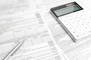 Business concept - financial report and pen, calculator and charts photo