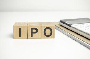 IPO word of wooden cube or block concept on wooden background. photo