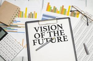 Vision Of The Future words on white notebook with colourful calculator and charts photo